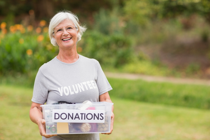 Happy grandmother holding donation box